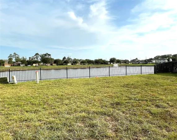 a view of a yard with wooden fence