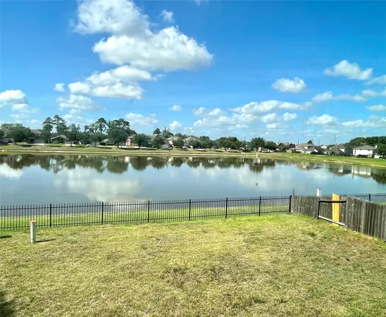 a view of a lake with houses in the back
