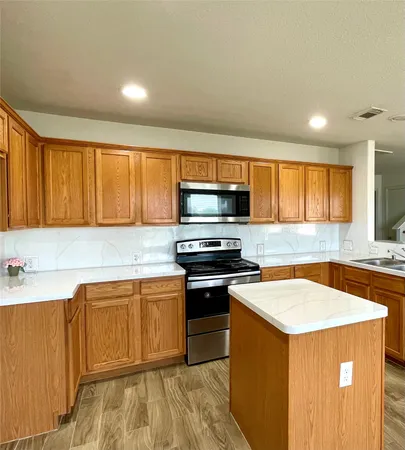 a kitchen with a stove a sink and a microwave