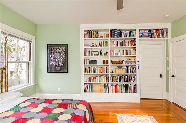 33 Manchester Road Brookline, MA 02446 - Photo 16 of 23 a bedroom with a bed lots of books and a large window