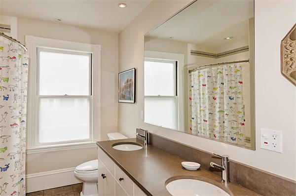 33 Manchester Road Brookline, MA 02446 - Photo 18 of 23 a bathroom with a granite countertop sink toilet a mirror and shower
