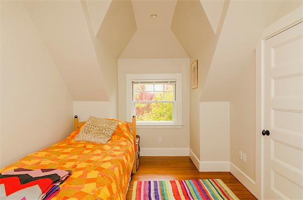 33 Manchester Road Brookline, MA 02446 - Photo 20 of 23 a bed sitting in a bedroom next to a window