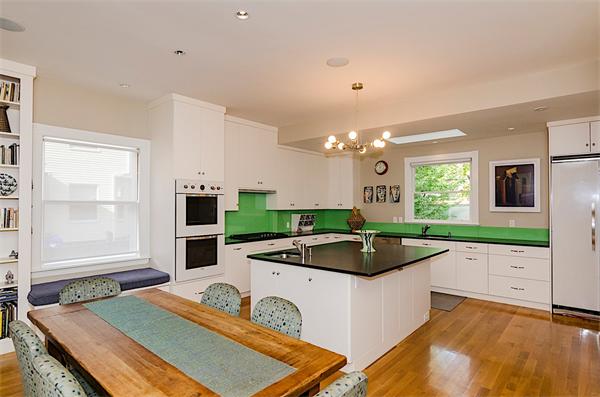 33 Manchester Road Brookline, MA 02446 - Photo 9 of 23 a kitchen with kitchen island granite countertop a sink and a stove next to a window