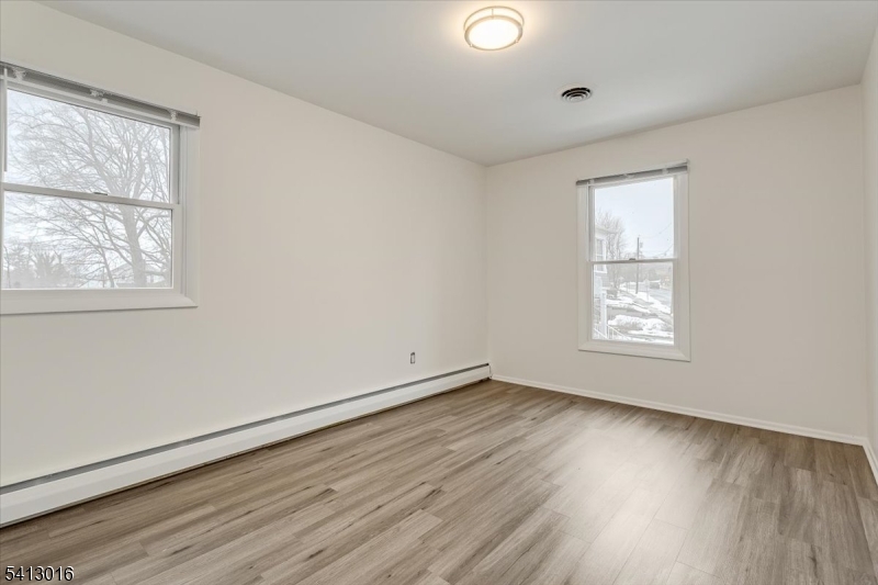 35 Field Road, Unit 2 Maplewood, NJ 07040 - Photo 12 of 13 an empty room with wooden floor and windows