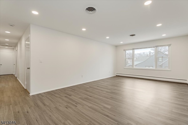 35 Field Road, Unit 2 Maplewood, NJ 07040 - Photo 2 of 13 an empty room with wooden floor and window