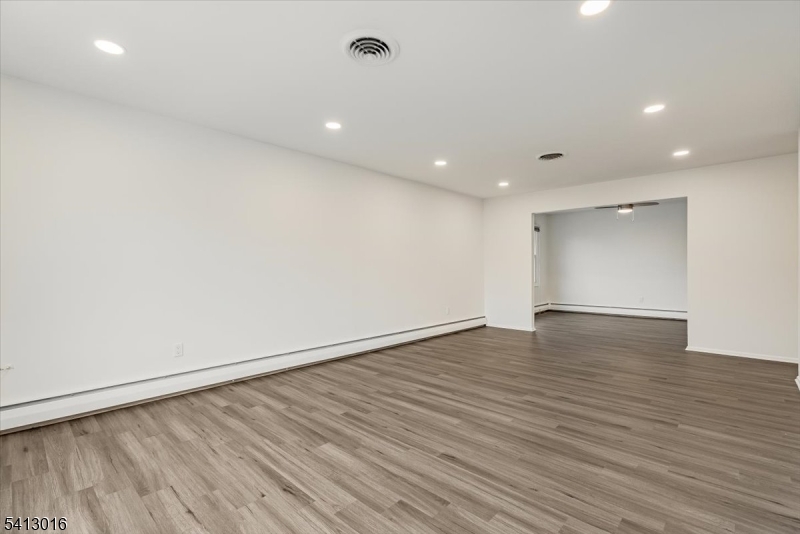 35 Field Road, Unit 2 Maplewood, NJ 07040 - Photo 4 of 13 an empty room with wooden floor and windows