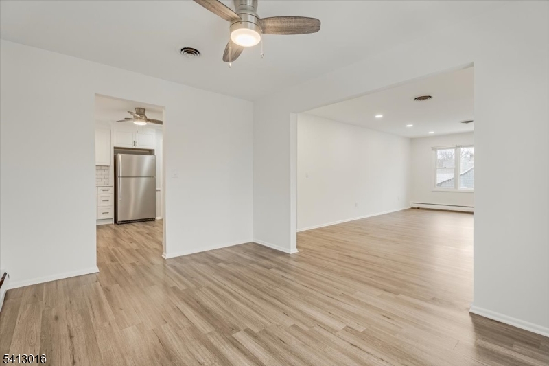35 Field Road, Unit 2 Maplewood, NJ 07040 - Photo 5 of 13 an empty room with wooden floor and windows