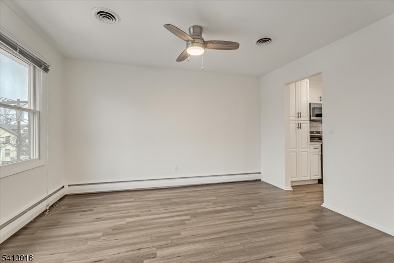35 Field Road, Unit 2 Maplewood, NJ 07040 - Photo 7 of 13 wooden floor in an empty room with a window