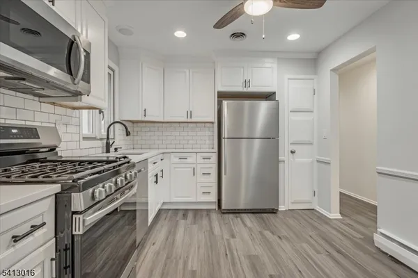 a kitchen with wooden floors and appliances