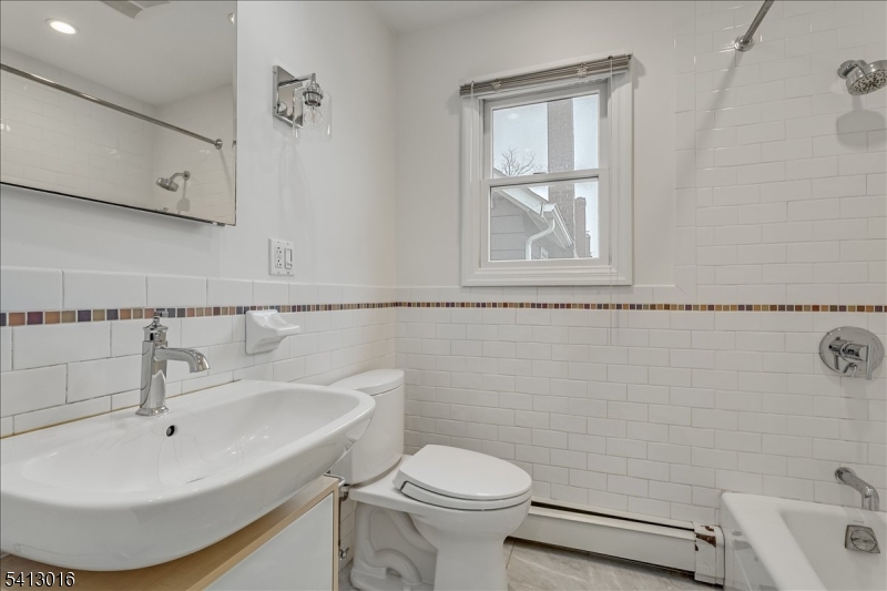 35 Field Road, Unit 2 Maplewood, NJ 07040 - Photo 10 of 13 a bathroom with a sink a toilet and vanity
