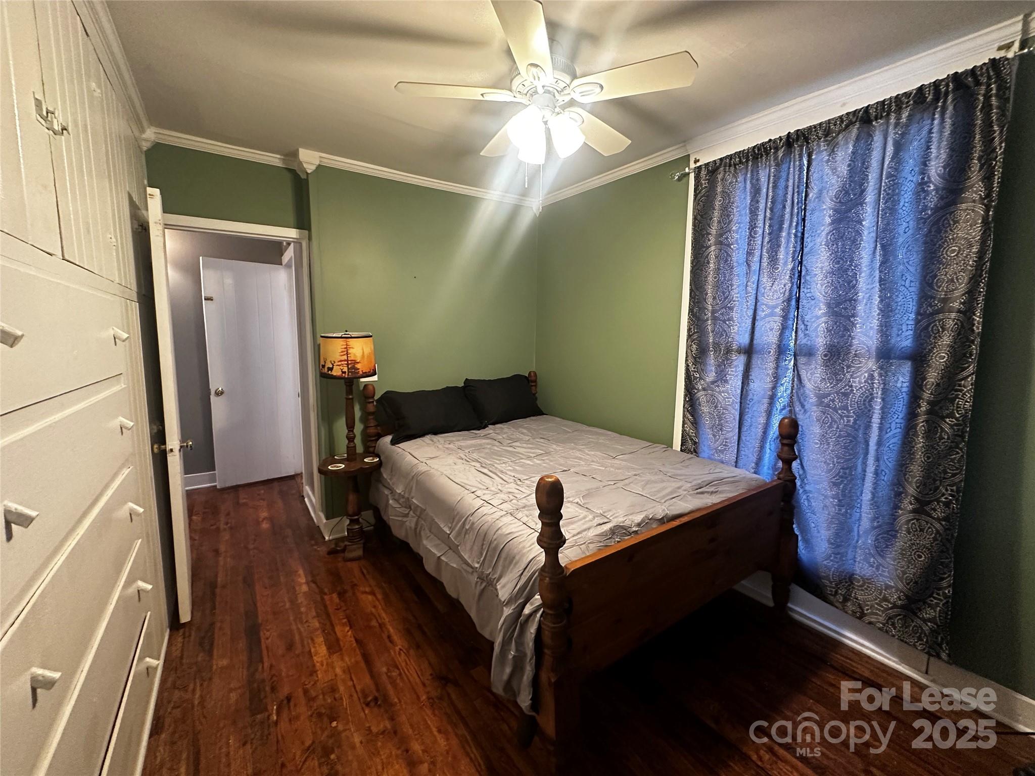 717 Deep Gap Road Burnsville, NC 28714 - Photo 17 of 23 a bedroom with a bed and a chandelier