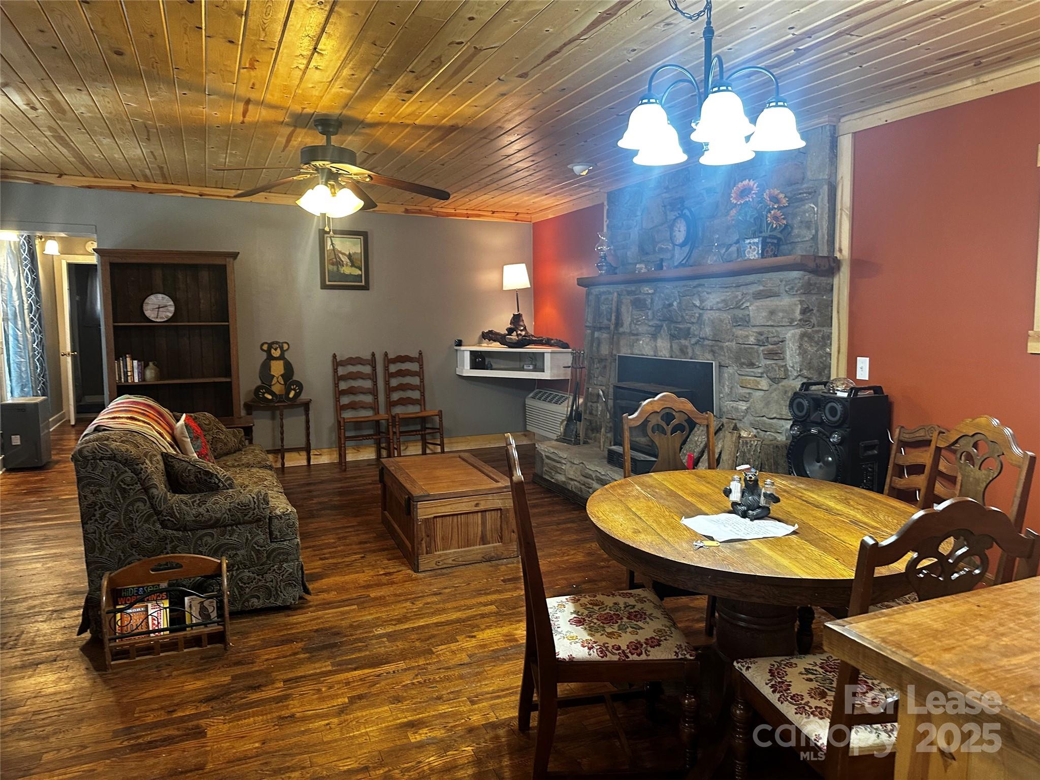 717 Deep Gap Road Burnsville, NC 28714 - Photo 20 of 23 a living room with furniture a chandelier and a fireplace