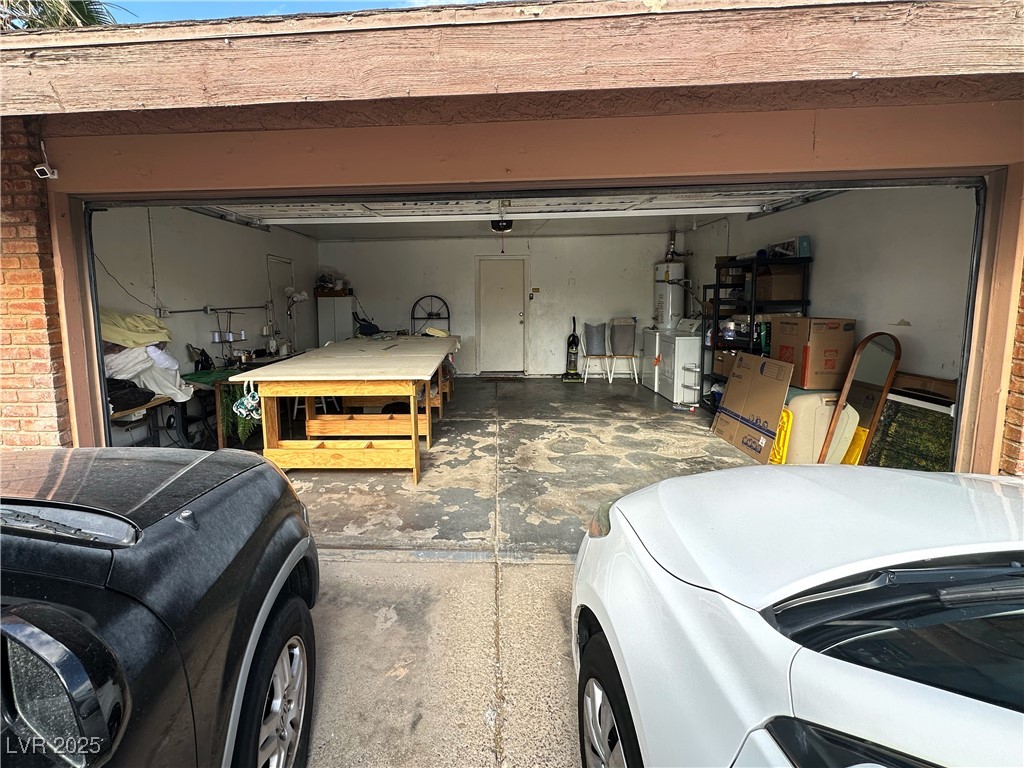 3936 Rive Gauche Street Las Vegas, NV 89115 - Photo 6 of 30 Garage featuring washer and dryer and secured water heater