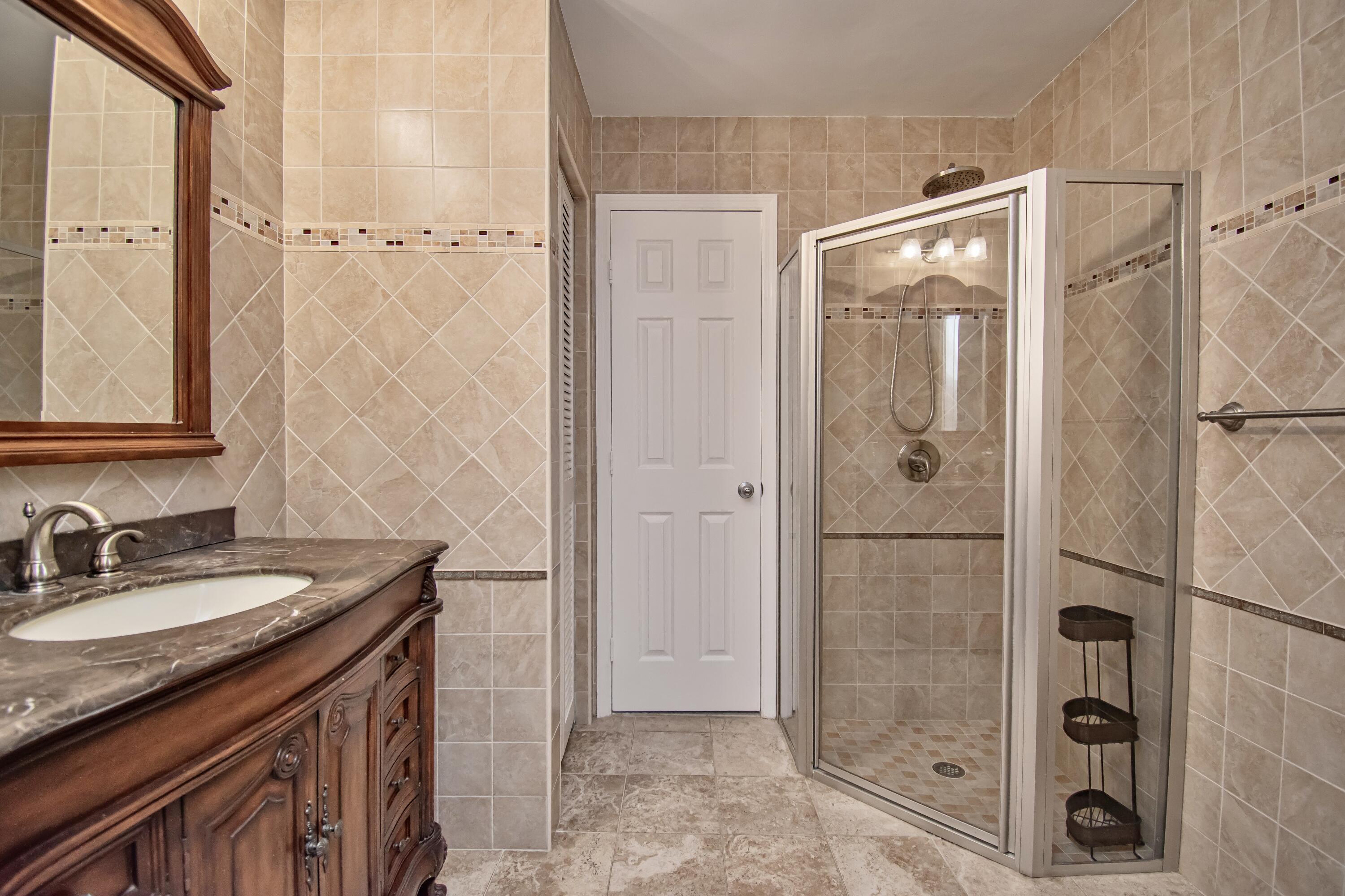 7838 Cypress Crescent Boca Raton, FL 33433 - Photo 18 of 24 a bathroom with a granite countertop shower sink and mirror