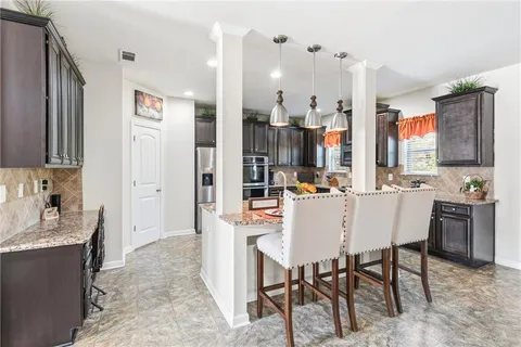 a kitchen with stainless steel appliances granite countertop a stove sink and cabinets