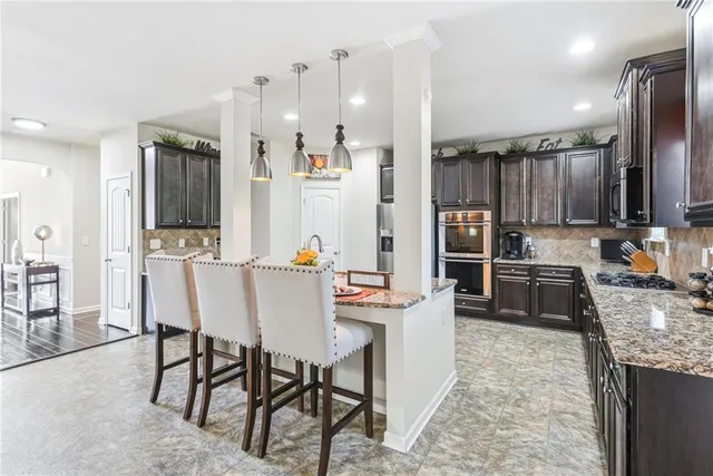 a kitchen with granite countertop a sink stove and cabinets