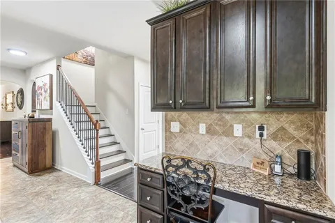 a living room with furniture a rug and a fireplace