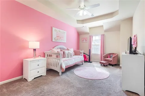 a spacious bathroom with a tub sink and mirror