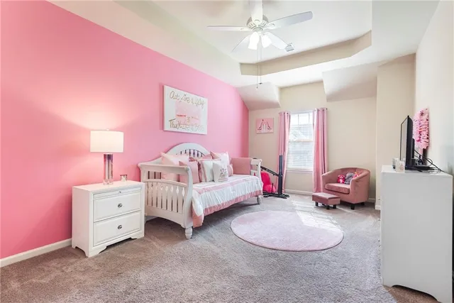 a spacious bathroom with a tub sink and mirror