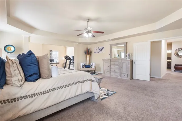 a living room with patio furniture and a potted plant