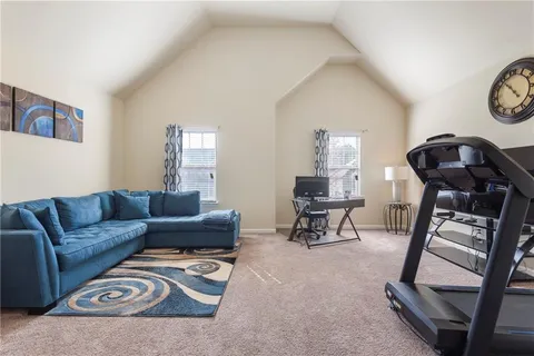 a living room with furniture ceiling fan and a potted plant