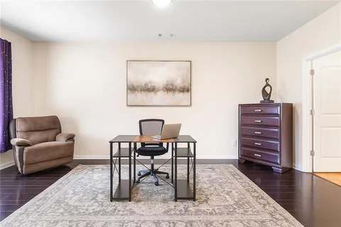 a living room with furniture a dining table and a chandelier