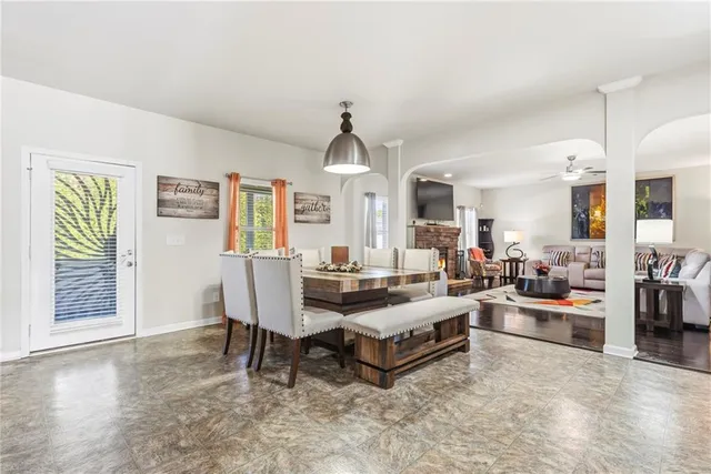 a kitchen with stainless steel appliances kitchen island granite countertop a stove a sink dishwasher and a refrigerator with wooden floor