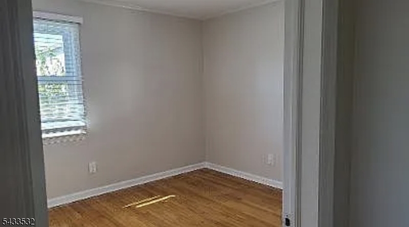 16 Ocean Street Millburn, NJ 07041 - Photo 24 of 26 a view of an empty room with wooden floor and a window
