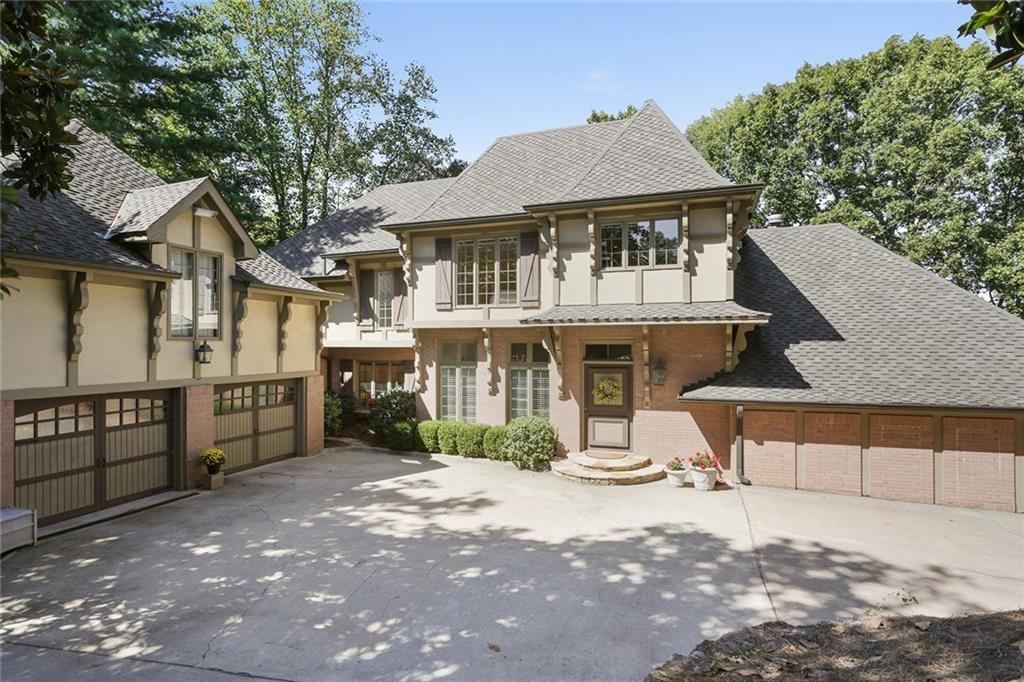 Emily Ann Smith stuns with the architectural gem in Sandy Springs. Nestled into a stone lined driveway, this home surprises guests with its sweeping rooflines and tall windows. The carriage house garage is a "got to see to believe" space with gorgeous garage doors and an unfinished suite above stubbed for a full living space. Don't miss it at showing!!!