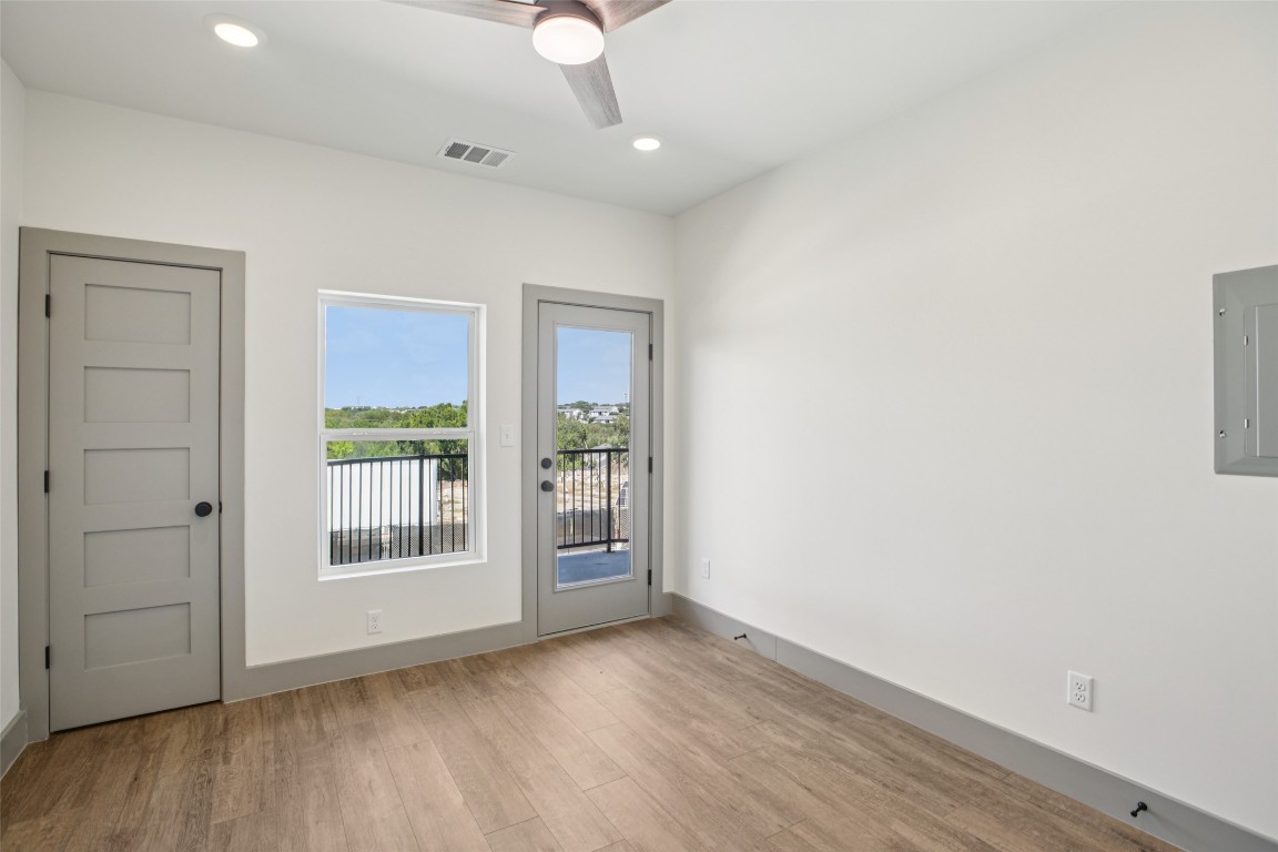 2450 Wickersham Lane, Unit 1917 Austin, TX 78741 - Photo 11 of 18 Doorway with wood finished floors, recessed lighting, electric panel, and a ceiling fan
