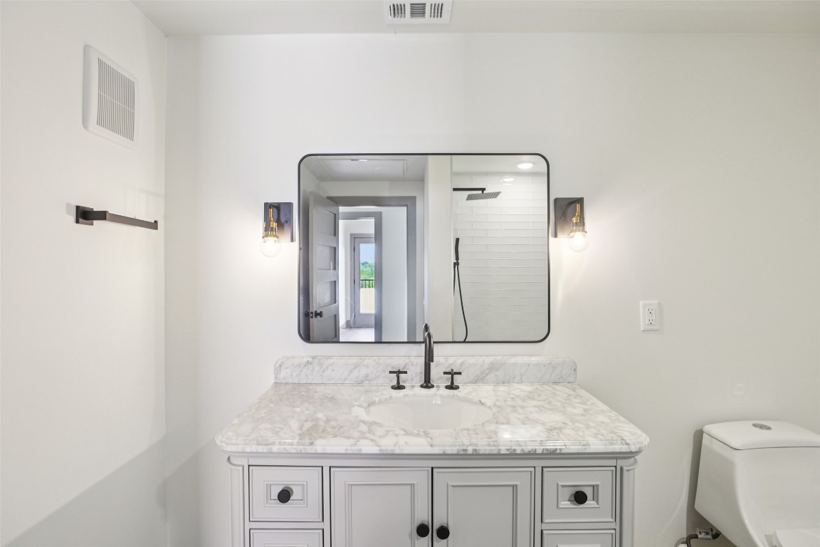 2450 Wickersham Lane, Unit 1917 Austin, TX 78741 - Photo 15 of 18 Bathroom with vanity and a tile shower