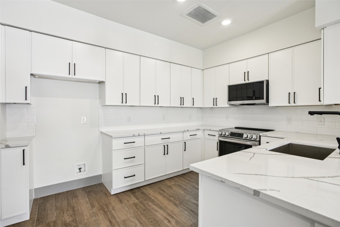 2450 Wickersham Lane, Unit 1917 Austin, TX 78741 - Photo 4 of 18 Kitchen featuring decorative backsplash, appliances with stainless steel finishes, light stone counters, and recessed lighting