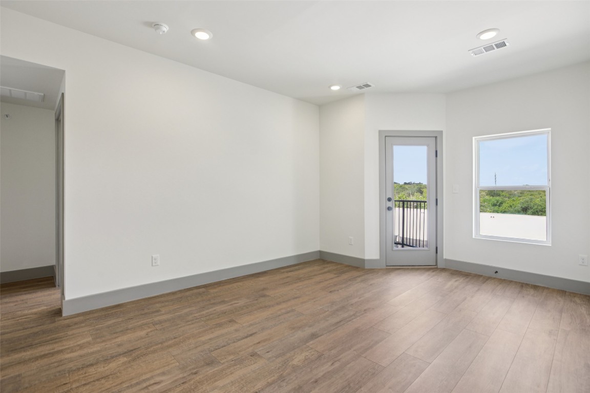 2450 Wickersham Lane, Unit 1917 Austin, TX 78741 - Photo 8 of 18 Empty room featuring recessed lighting and wood finished floors