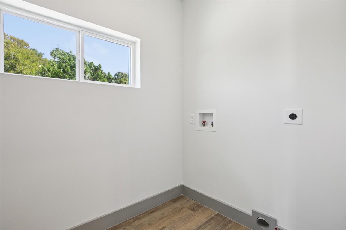 2450 Wickersham Lane, Unit 1917 Austin, TX 78741 - Photo 9 of 18 Washroom featuring wood finished floors, electric dryer hookup, and washer hookup