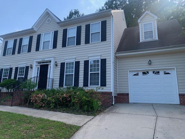8320 Hobhouse Circle Raleigh, NC 27615 - Photo 1 of 16 a front view of a house with a garden