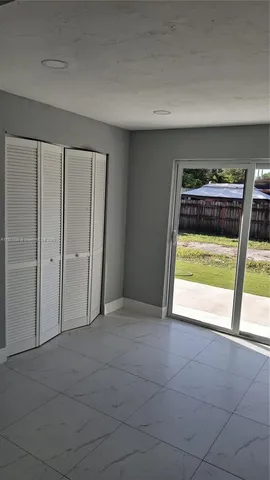 a view of an empty room with a window