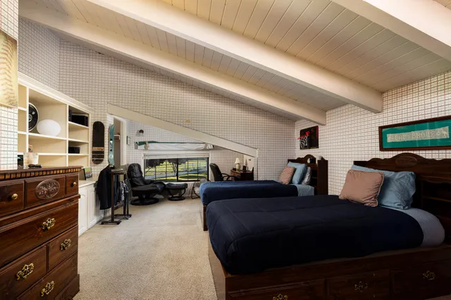 a living room with furniture a flat screen tv and gym equipment
