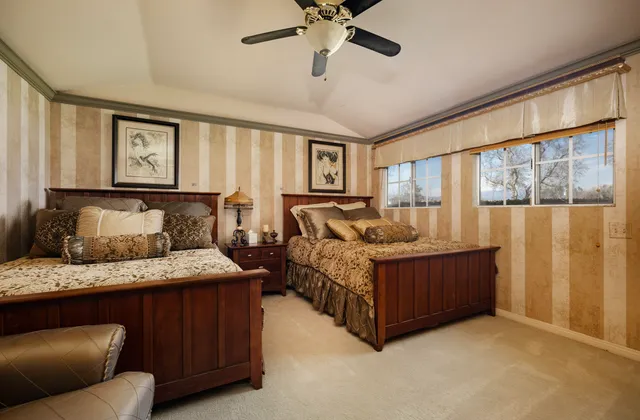 a bedroom with a bed window and couch