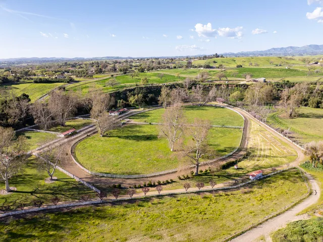 a view of a swimming pool with a table and chairs