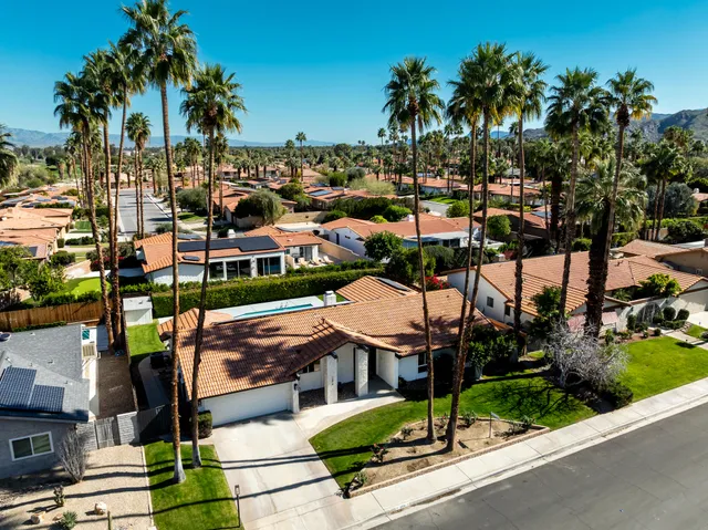 a view of a patio with swimming pool and furniture