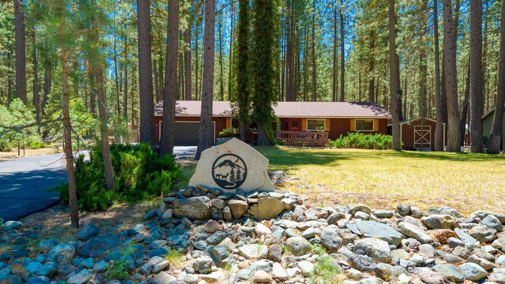 11 Shasta Trail Graeagle, CA 96103 - Photo 1 of 28 a front view of a house with garden