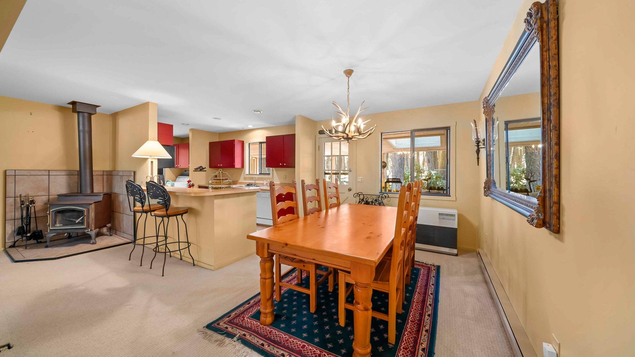 11 Shasta Trail Graeagle, CA 96103 - Photo 11 of 28 a dining room with furniture a fireplace and chandelier