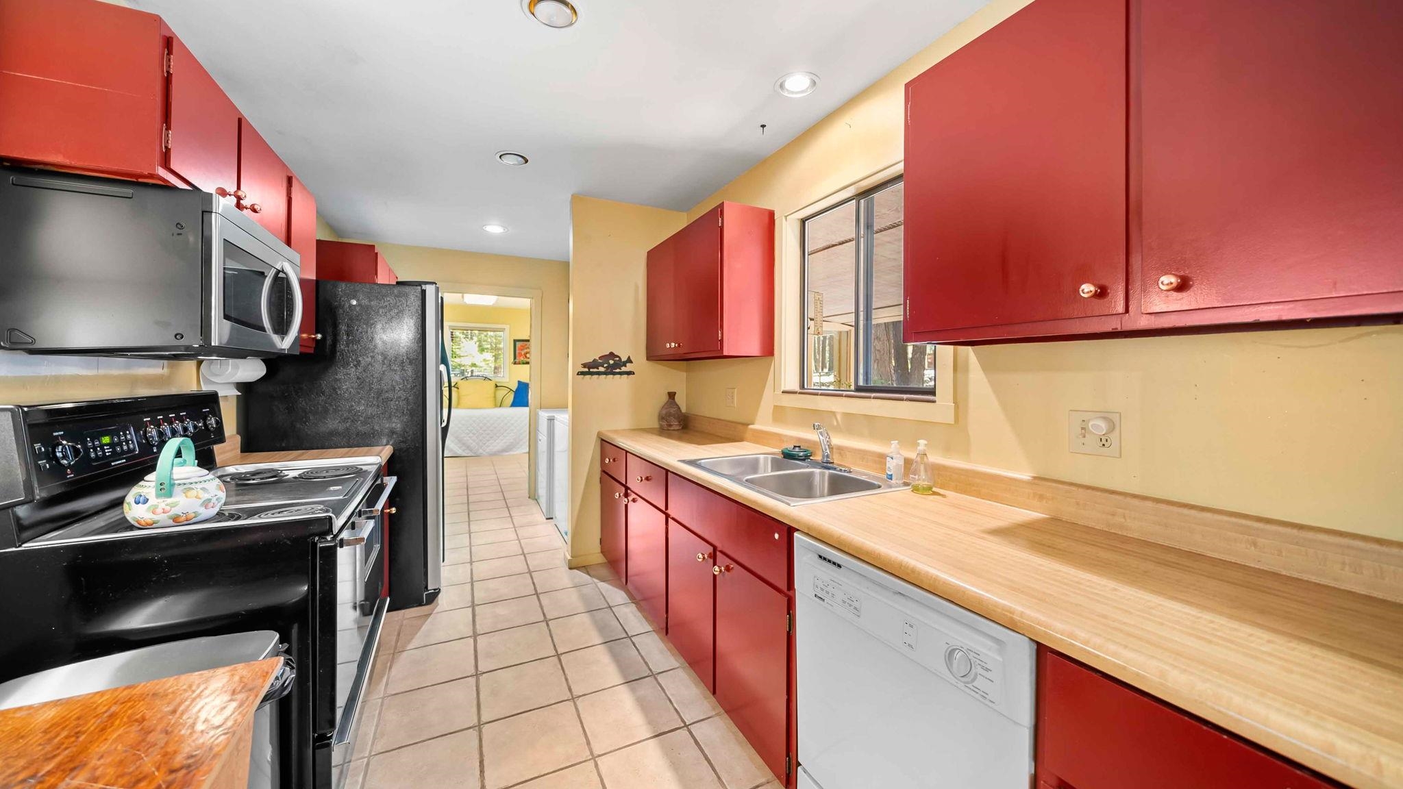 11 Shasta Trail Graeagle, CA 96103 - Photo 13 of 28 a kitchen with stainless steel appliances a stove a sink and a microwave