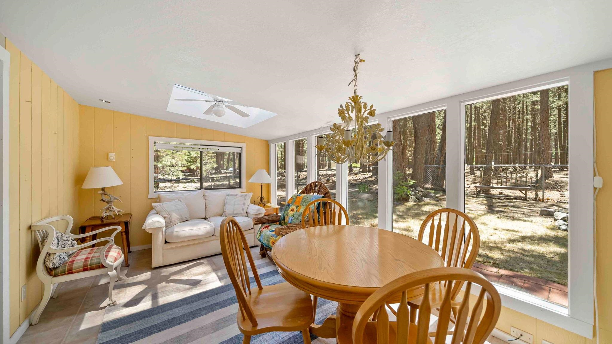 11 Shasta Trail Graeagle, CA 96103 - Photo 16 of 28 a dining room with furniture a chandelier and wooden floor