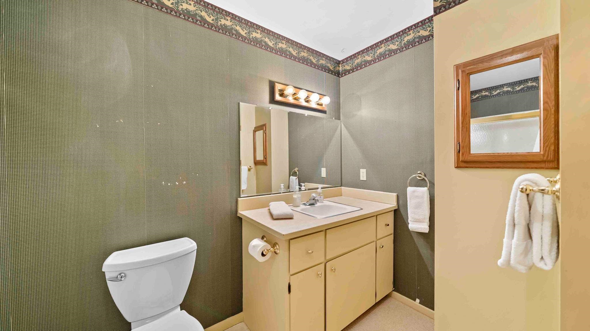 11 Shasta Trail Graeagle, CA 96103 - Photo 24 of 28 a bathroom with a granite countertop toilet sink and mirror