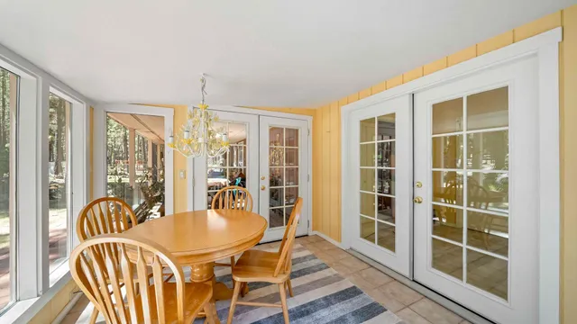 a dining room with furniture windows and wooden floor