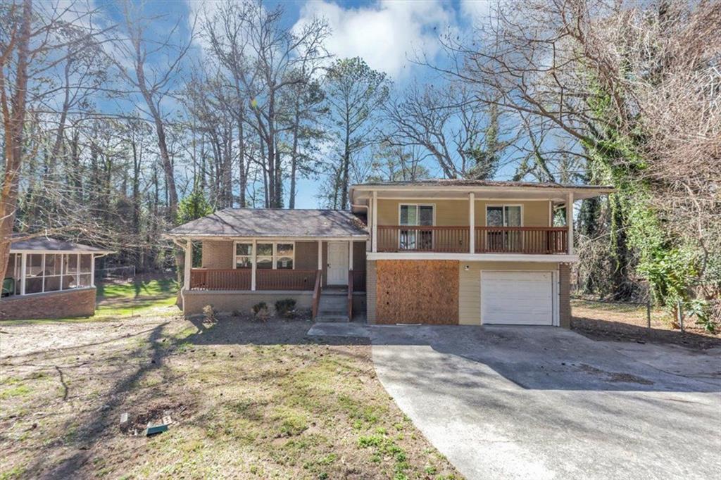 389 Harlan Road Southwest Atlanta, GA 30311 - Photo 1 of 1 a view of a house with a yard covered in snow