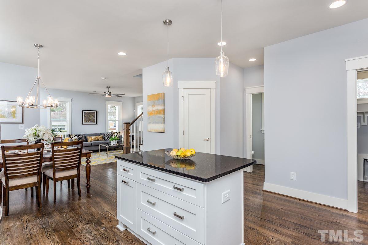 830 Coleman Street Raleigh, NC 27610 - Photo 11 of 24 a kitchen with sink cabinets and dining table