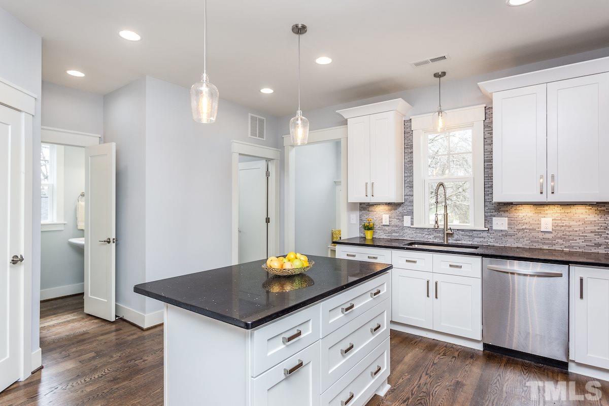 830 Coleman Street Raleigh, NC 27610 - Photo 12 of 24 a kitchen with granite countertop a sink cabinets and wooden floor