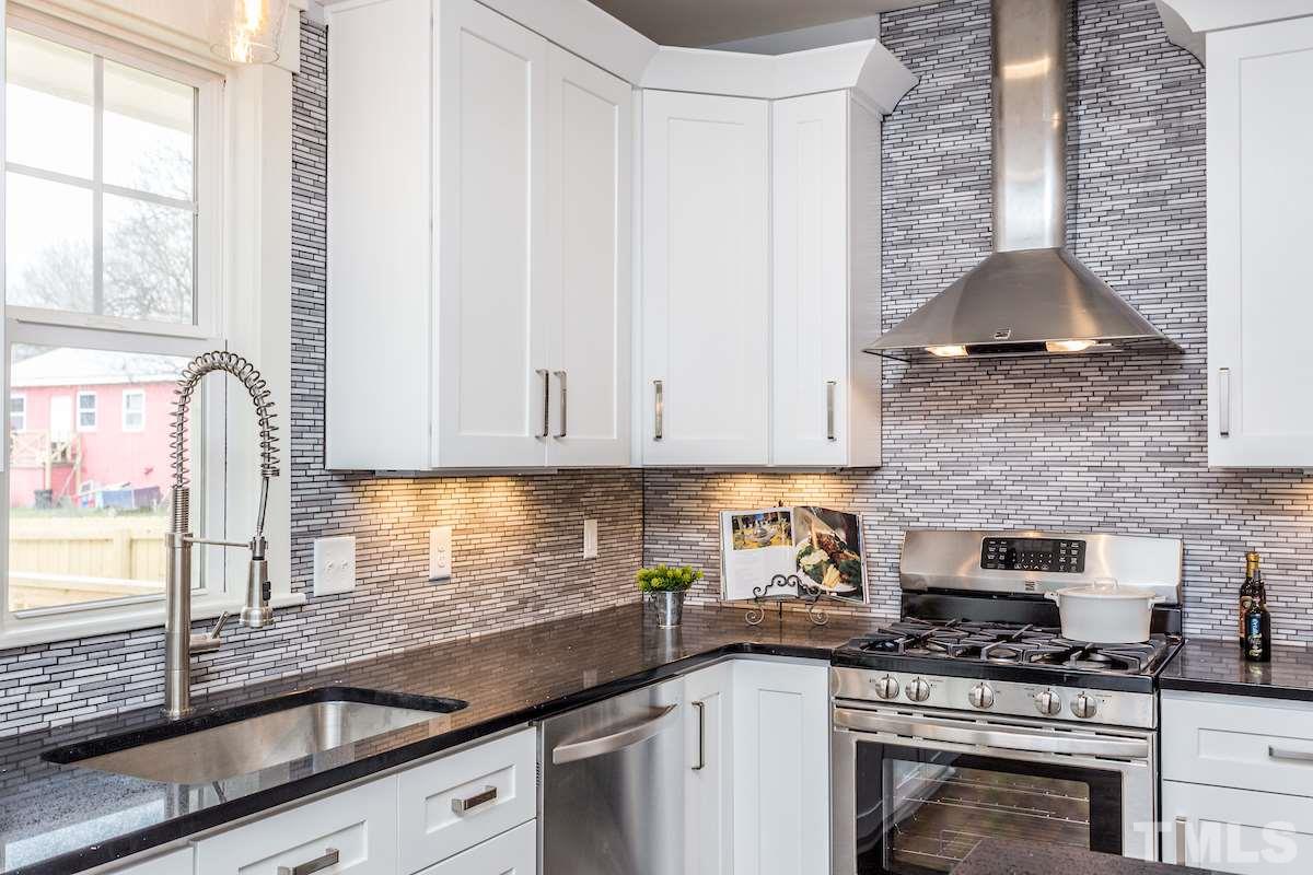 830 Coleman Street Raleigh, NC 27610 - Photo 13 of 24 a kitchen with granite countertop a sink a stove and cabinets